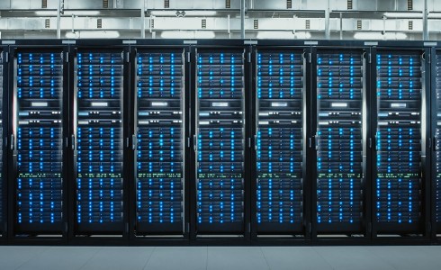 Camera Slide-Trough Shot of a Working Data Center With Rows of Rack Servers. Led Lights Blinking and Computers are Working.